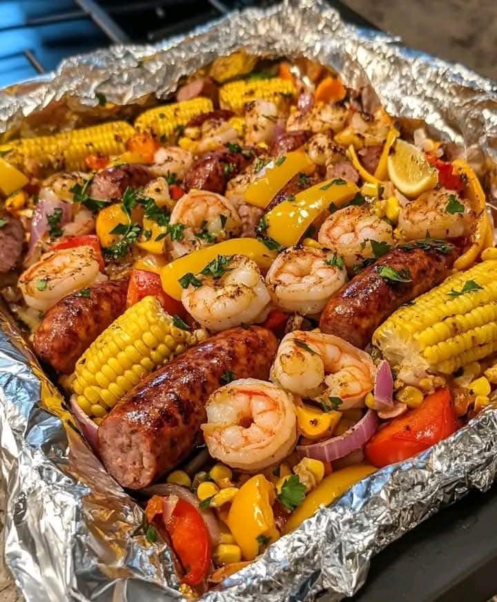 Easy and flavorful Shrimp and Sausage Foil Packet Dinner packed with seasoned veggies and juicy proteins.