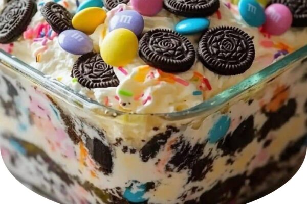 Festive and fun Easter Dirt Cake Casserole with layers of creamy pudding, crushed cookies, and colorful toppings.