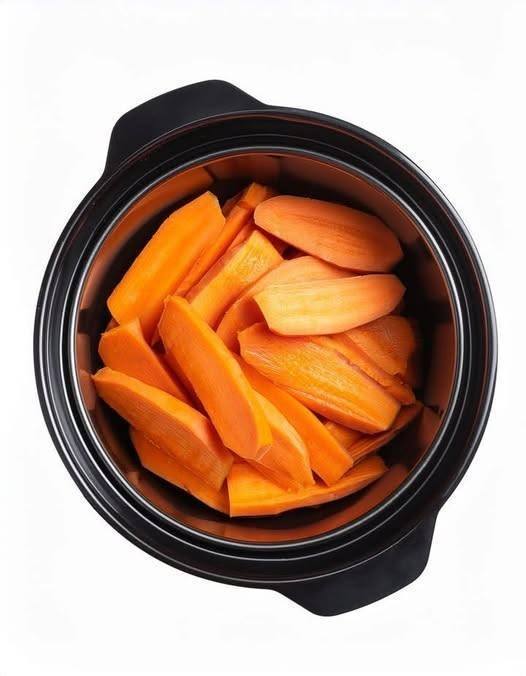 Put raw thinly sliced sweet potatoes in a slow cooker with these 4 ingredients. You’ll never eat them another way..