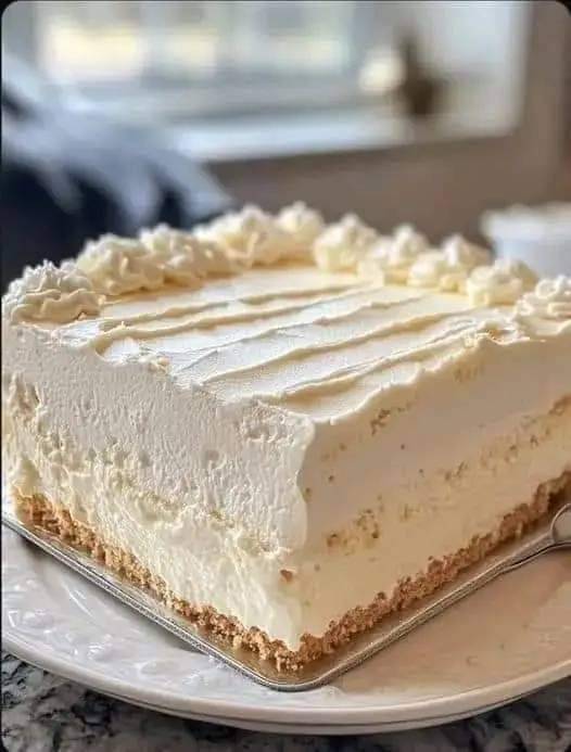 This traditional cream cheese cake is a delicious dessert that mixes the tasty cream cheese flavor with a light and fluffy cake. The smooth icing gives just the right amount of sweetness